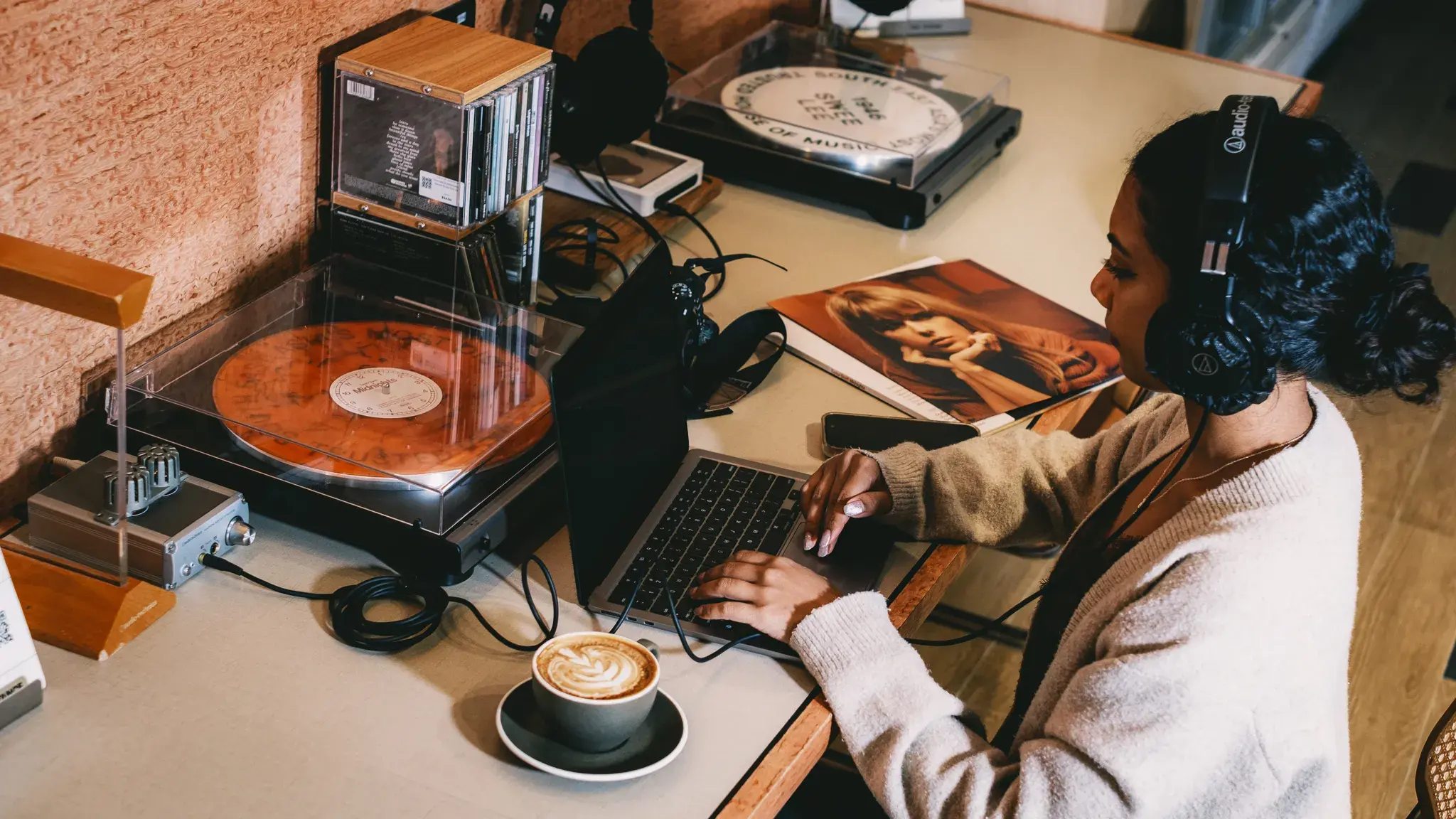 A music lover listening to vinyl while browsing VMI Connect
