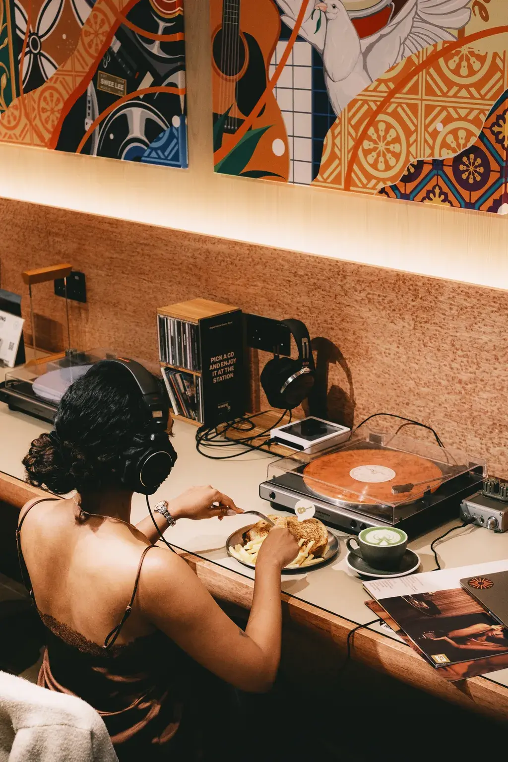 A music lover listening to vinyl while browsing VMI Connect